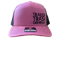 A pink and black trucker hat with 'TRAILER TRASH COMPANY' printed in black on the front panels and a black mesh back, shown against a plain white background.