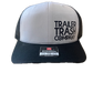 A black and white trucker hat with 'TRAILER TRASH COMPANY' printed on the front panel and a visible 'Moto 112' sticker on the side, shown against a plain white background.
