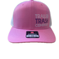 Pink trucker hat with a curved brim, featuring 'TRAILER TRASH COMPANY' printed on the front panel and a black and white size patch on the side.