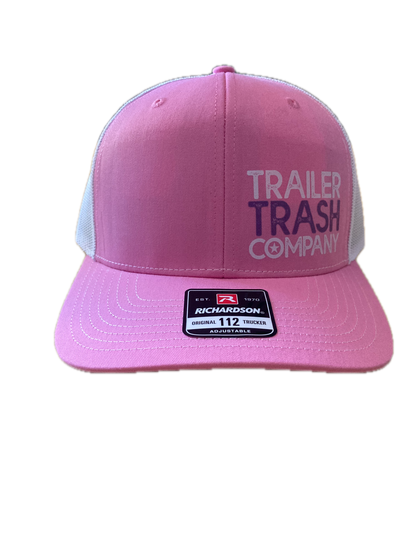 Pink trucker hat with a curved brim, featuring 'TRAILER TRASH COMPANY' printed on the front panel and a black and white size patch on the side.